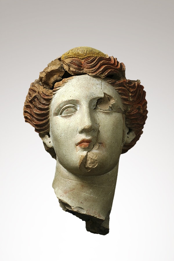 Female head in polychrome terracotta